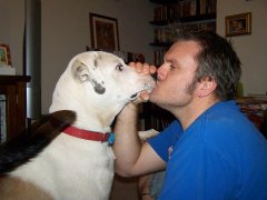 Holding his mouth so he doesn't slip the tongue in...