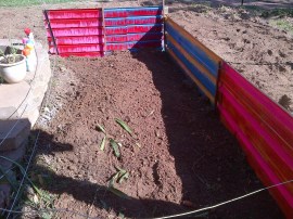 This area gets some grey water runoff, so I want it blocked off and we'll grow mint there.  Gemma went all arty on it to pretty it up.