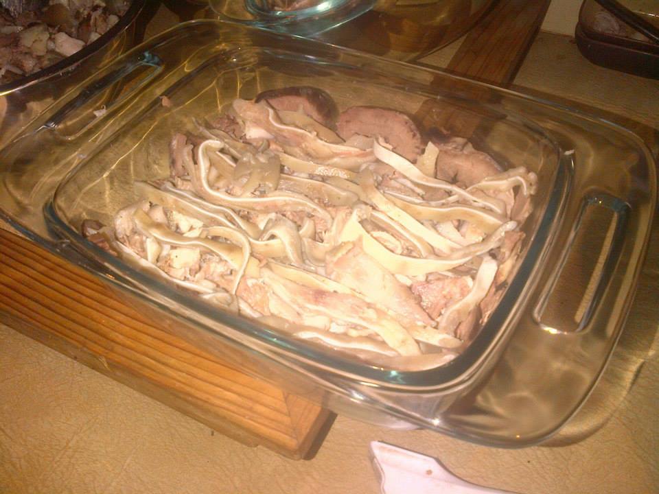 Layering the terrine.  The tongue and heart are around the sides and the bottom, which will become the top.  I laid the thinly cut ears in the middle.