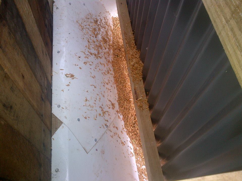 This is the baffle that makes sure the grain gravity feeds into the trough.