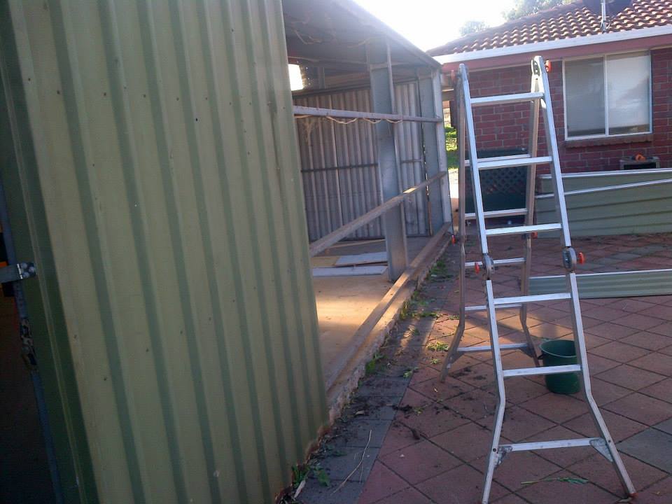 Taking the sheets of tin off.