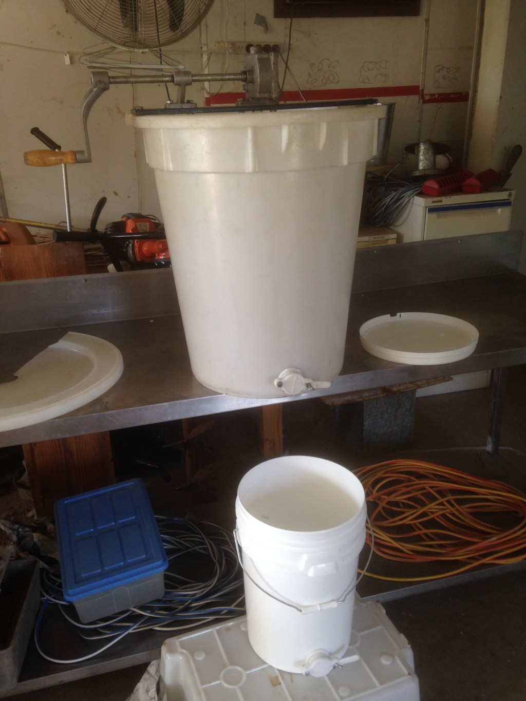 The extractor set up to flow into our honey bucket. Linhda did make me filter it through a colander with cloth over it. She apparently doesn't like bee bits in her honey.