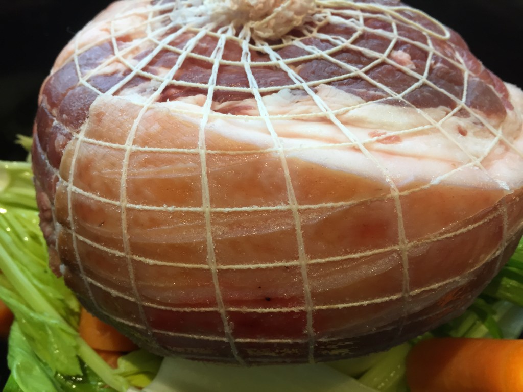 My rolled roast sitting on my trusty trio of veg!